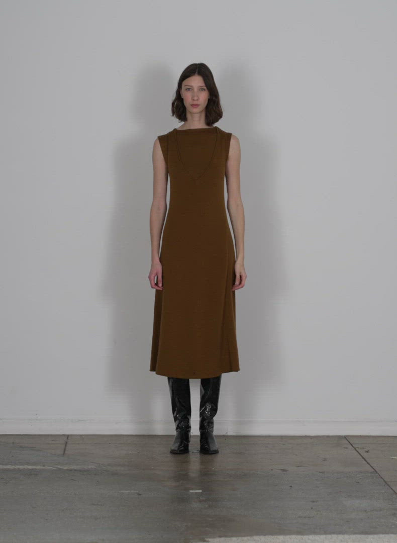 Model wearing the organic cotton tencel vneck cami dress burnt brown walking forward and turning around