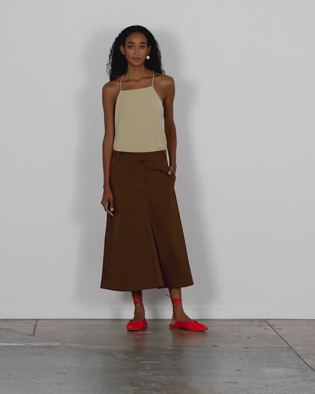 Model wearing the organic cotton twill maxi aline skirt walking forward and turning around