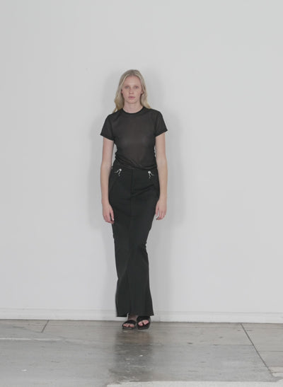 Model wearing the dominic pinstripe overall skirt black white multi walking forward and turning around