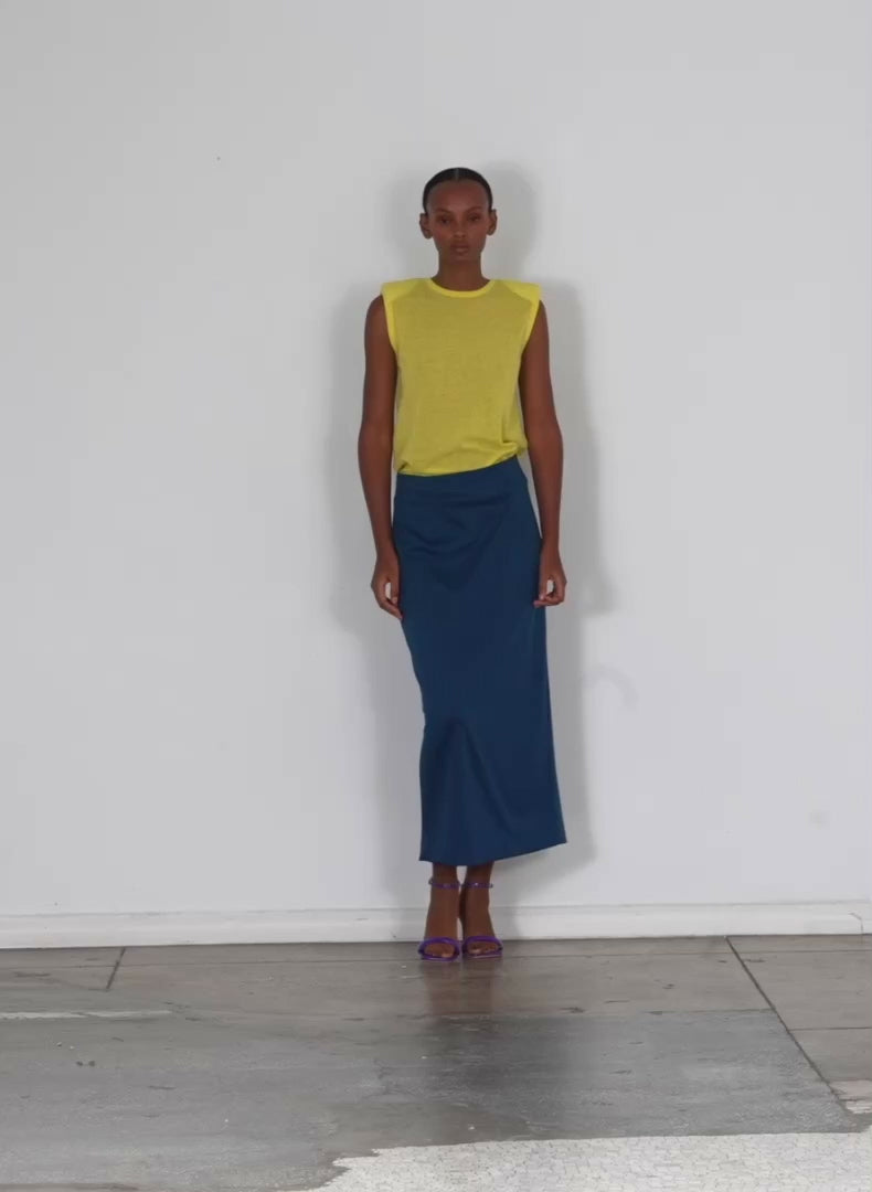 Model wearing the structured knit pencil skirt azure walking forward and turning around