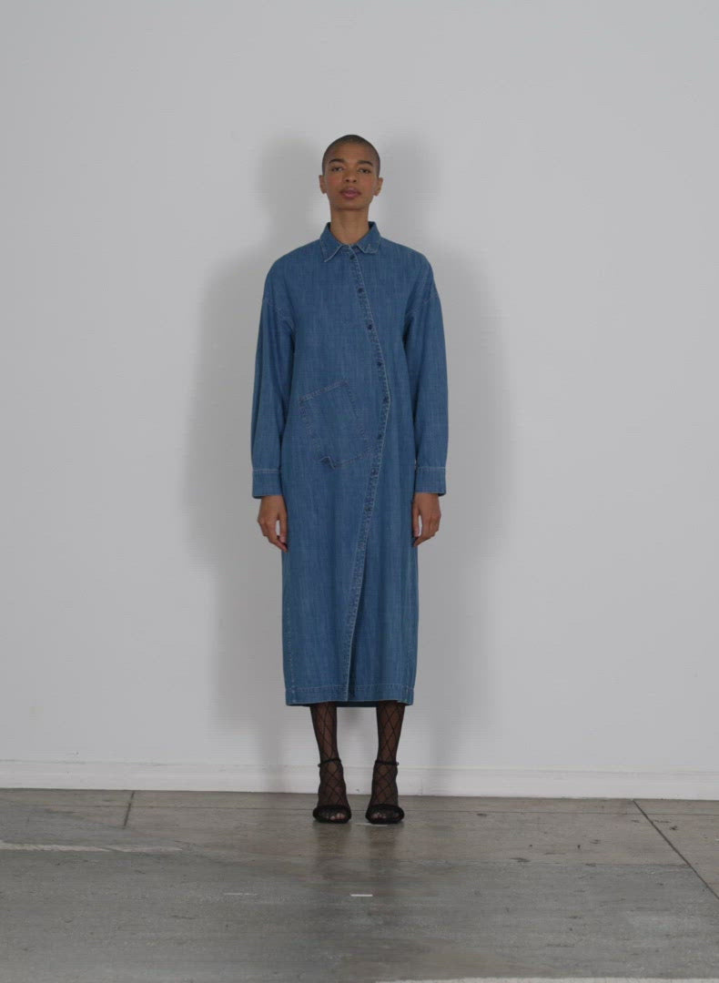 Model wearing the lightweight stone washed denim shirtdress denim blue walking forward and turning around