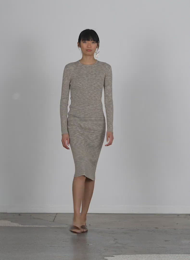 Model wearing the printed combed cotton crewneck shift dress walking forward and turning around