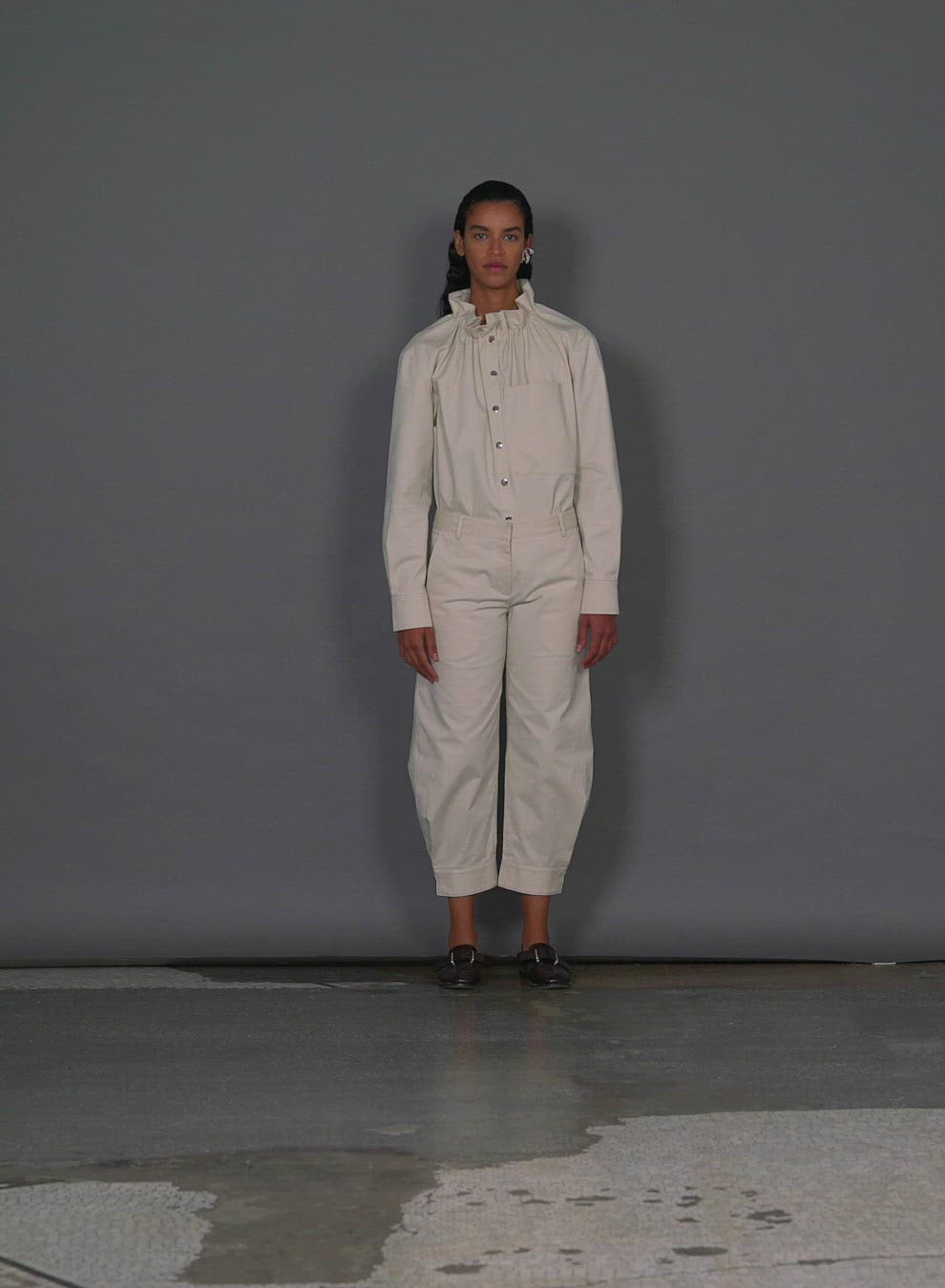 Model wearing the organic cotton twill sculpted pant walking forward and turning around