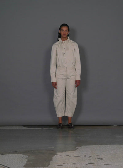 Model wearing the organic cotton twill sculpted pant walking forward and turning around