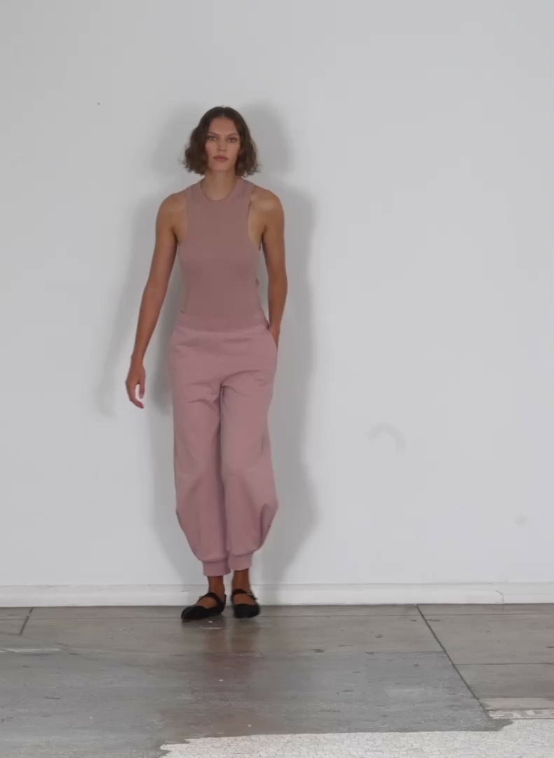 Model wearing the calder sweatpant toffee brown walking forward and turning around