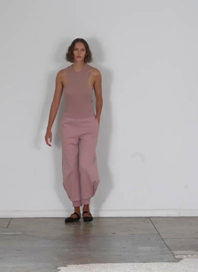 Model wearing the calder sweatpant toffee brown walking forward and turning around