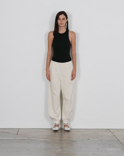 Model wearing the calder sweatpant ivory walking forward and turning around