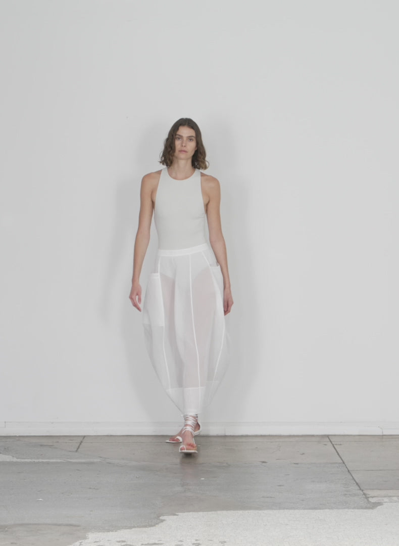 Model wearing the starch cotton organza lantern skirt white walking forward and turning around