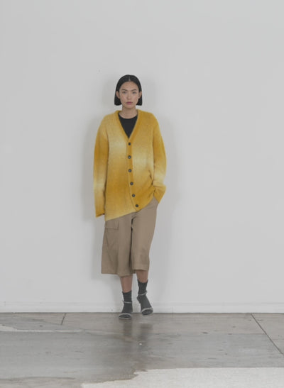 Model wearing the ombre superfine alpaca grandpa cardigan yellow multi walking forward and turning around