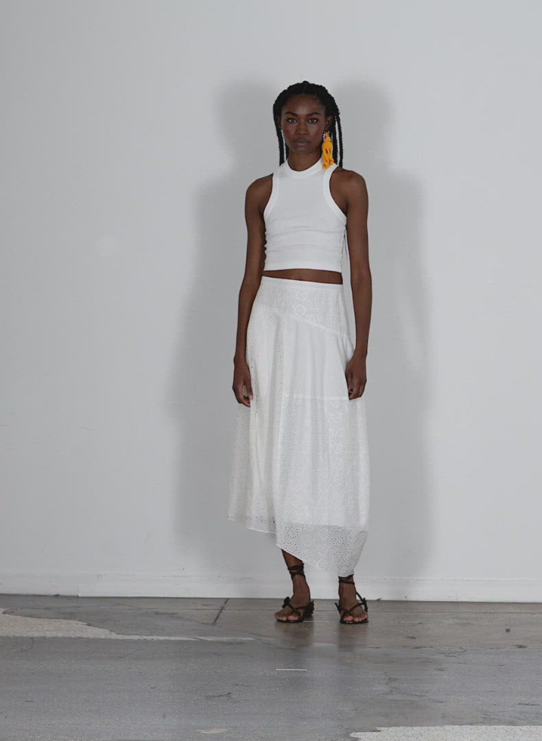 Model wearing the ribbed t cropped tank white walking forward and turning around