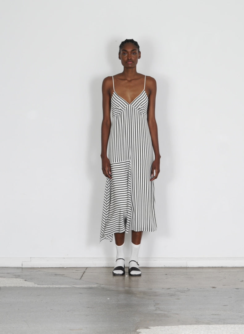 Model wearing the identity stripe cami dress black multi 1 walking forward and turning around