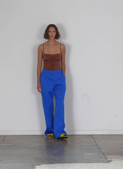 Model wearing the active knit wide leg pullon pant sapphire blue walking forward and turning around