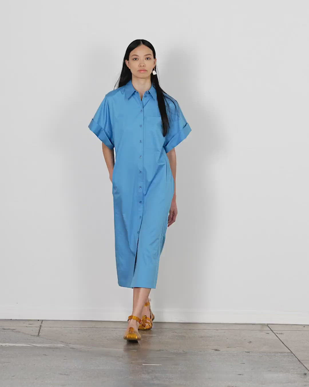 Model wearing the eco poplin rolled slv shirtdress walking forward and turning around