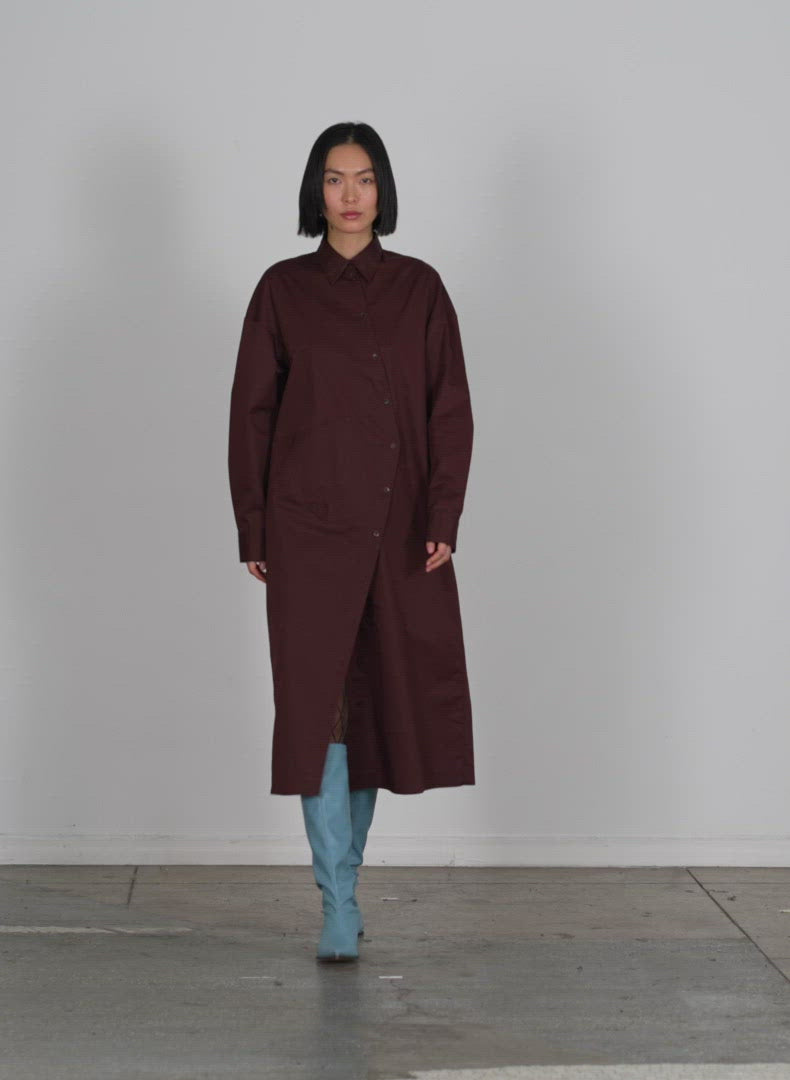 Model wearing the lightweight cotton sateen shirtdress brown walking forward and turning around