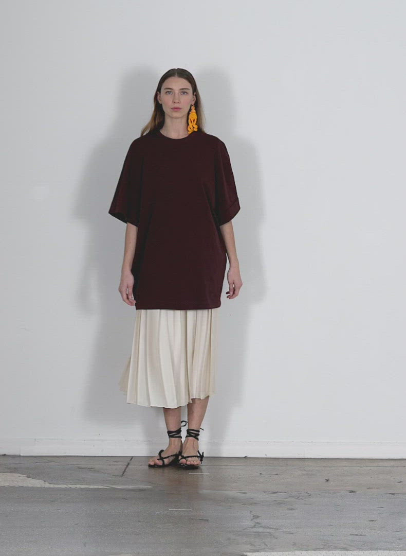 Model wearing the tshirting rolled sleeve tunic brown walking forward and turning around
