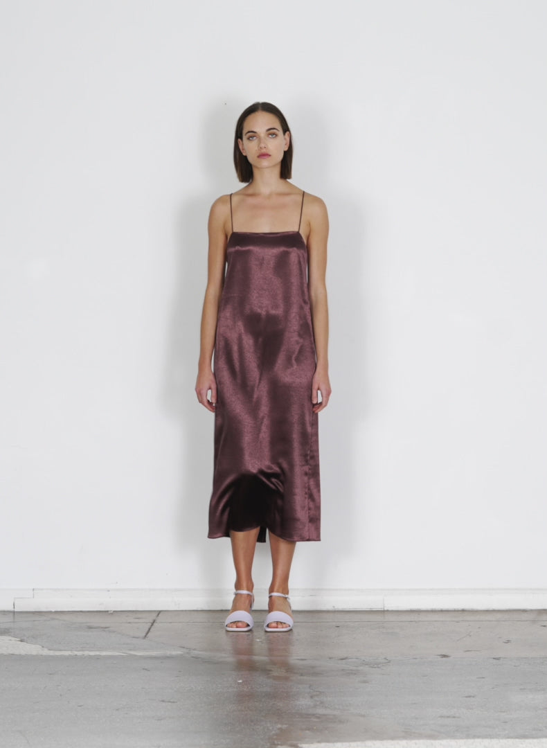 Model wearing the summer satin slip dress dark brown walking forward and turning around