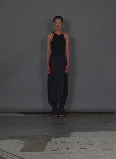 Model wearing the tropical wool stella pant w removable ankle bands heather grey walking forward and turning around