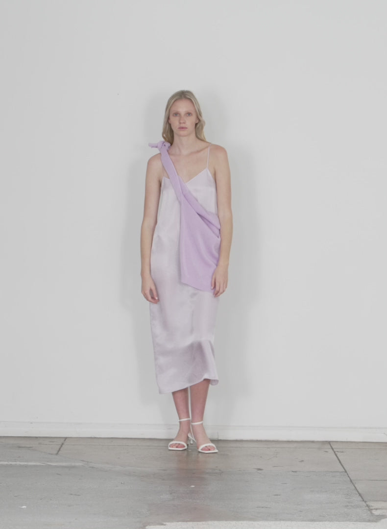 Model wearing the the slip dress dusty lavender walking forward and turning around