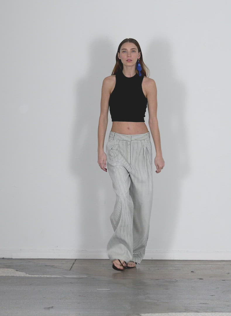 Model wearing the ribbed t cropped tank black walking forward and turning around