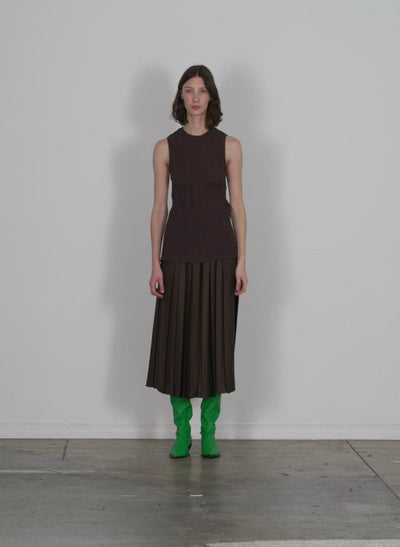 Model wearing the sage crinkle lyocell tank brown walking forward and turning around