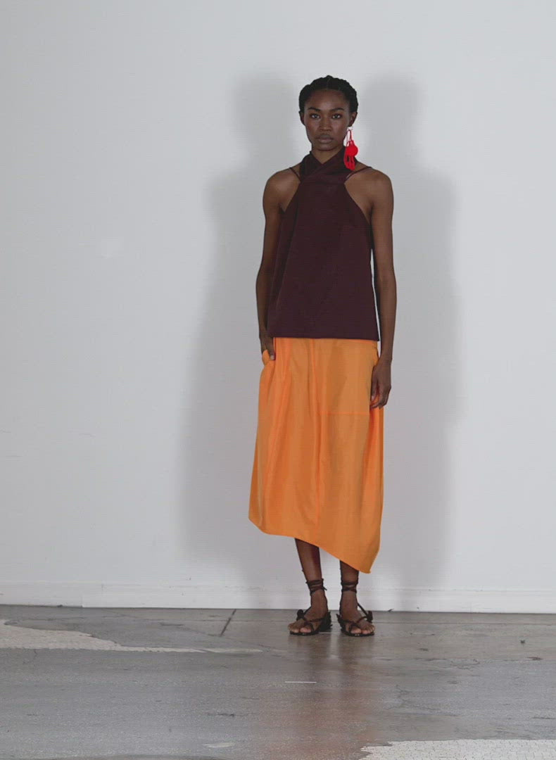 Model wearing the eco poplin halter top brown walking forward and turning around