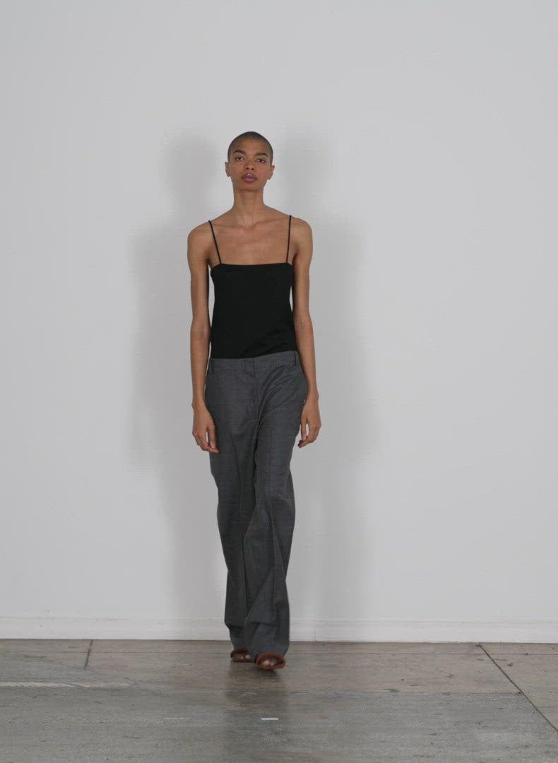 Model wearing the superfine wool flannel rodney straight leg trouser medium heather grey walking forward and turning around