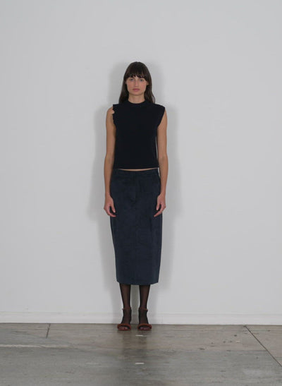 Model wearing the anna merino wool minime distressed vest dark navy walking forward and turning around