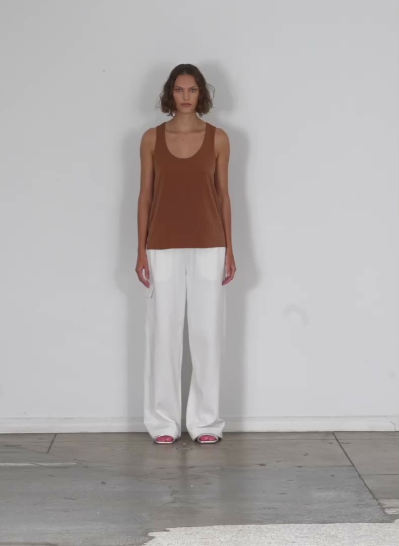 Model wearing the soft drape tank cocoa brown walking forward and turning around