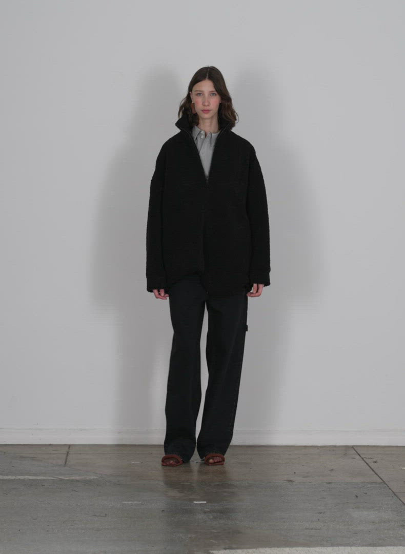 Model wearing the cozy fleece anorak zipup top dark stone walking forward and turning around