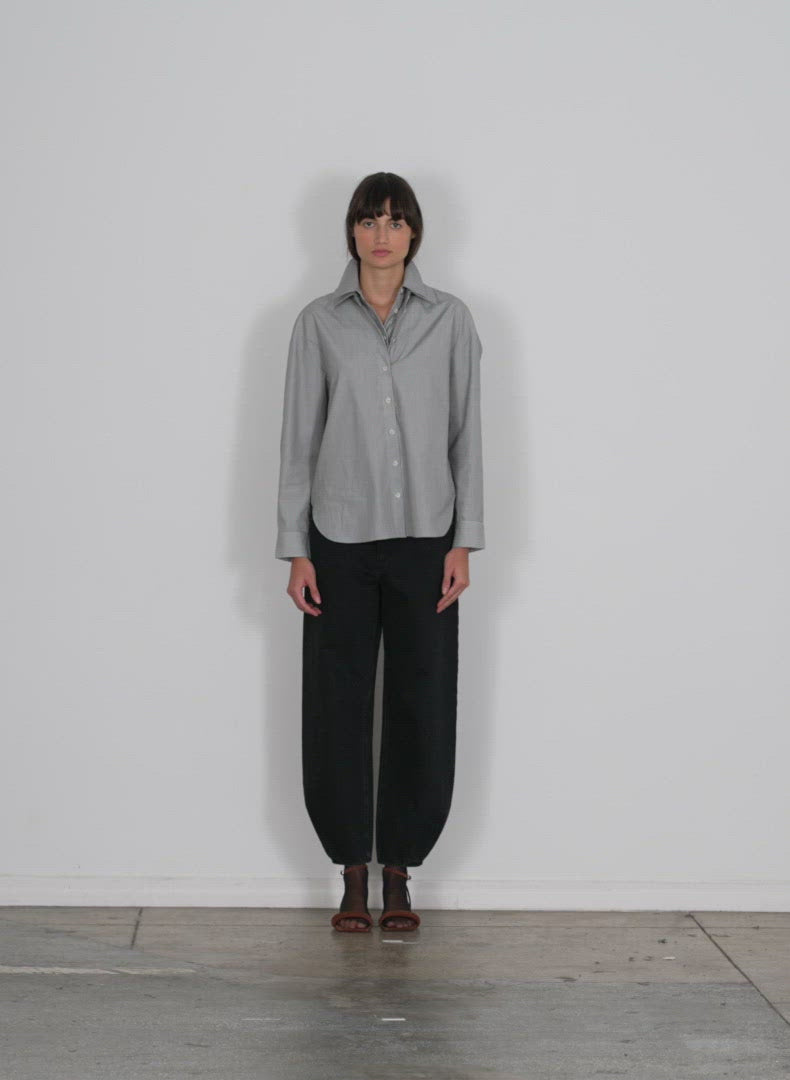 Model wearing the micro stripe double collar shirt black white multi walking forward and turning around