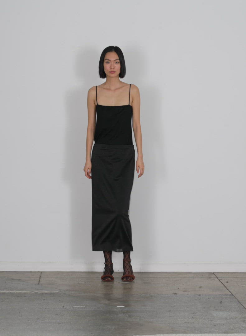 Model wearing the lurex haze pencil skirt black multi walking forward and turning around