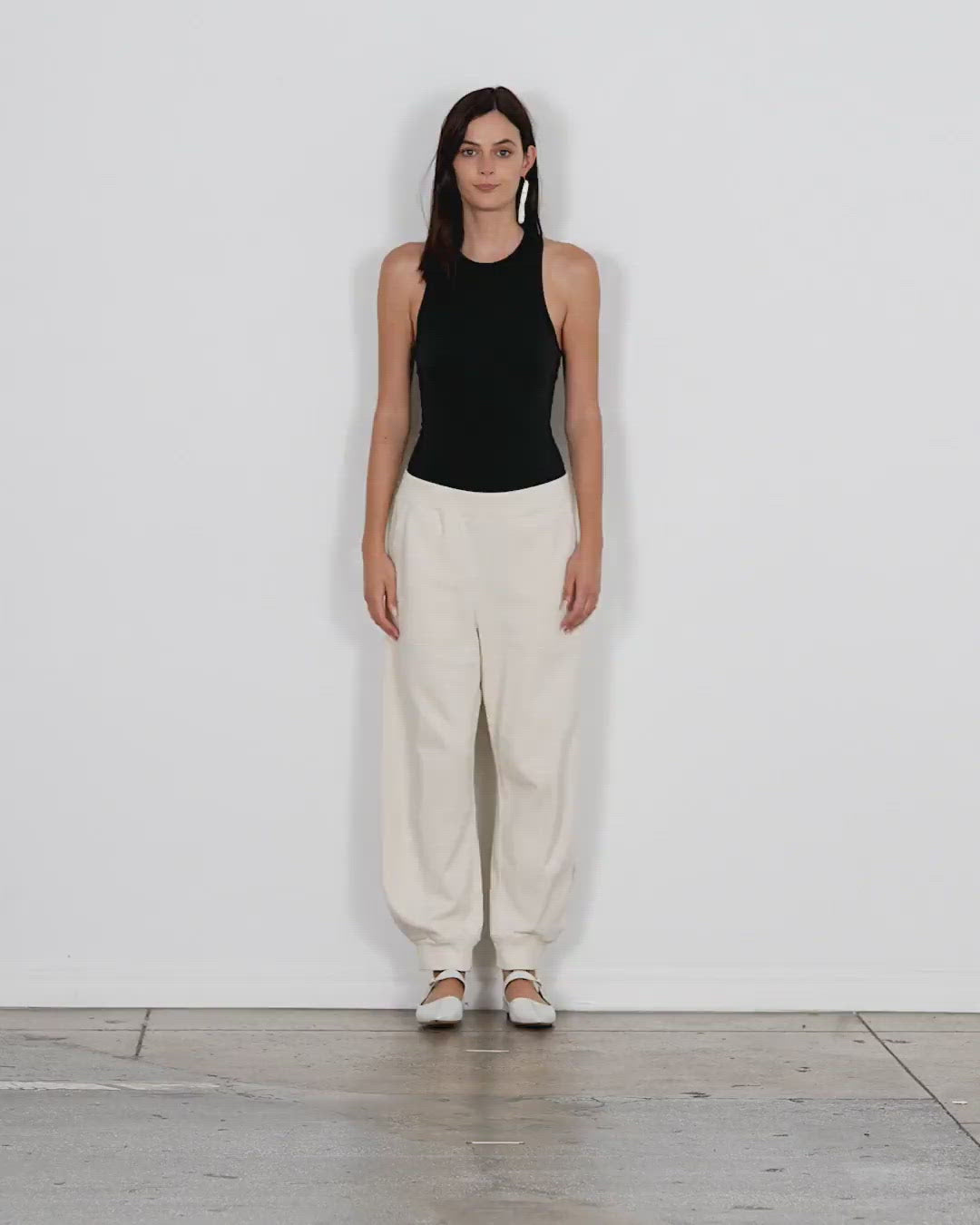 Model wearing the calder longer sweatpant ivory walking forward and turning around