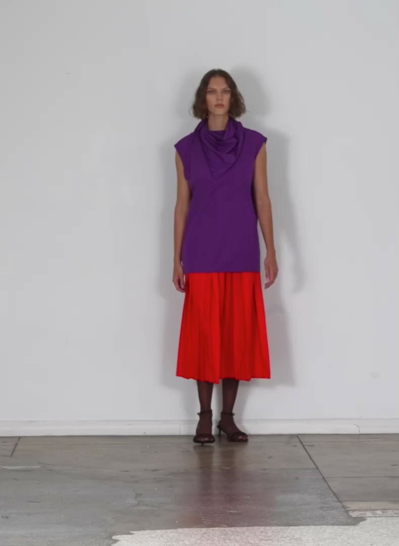 Model wearing the italian sporty nylon sleeveless cocoon top purple walking forward and turning around