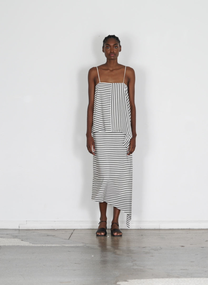 Model wearing the identity stripe pencil skirt black multi walking forward and turning around