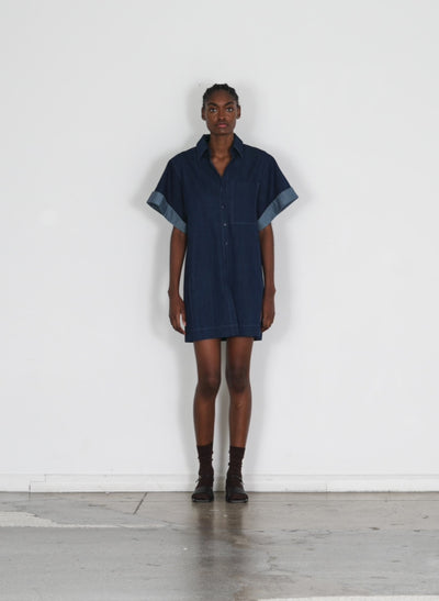 Model wearing the washed denim rolled slv shirtdress dark enzyme wash walking forward and turning around