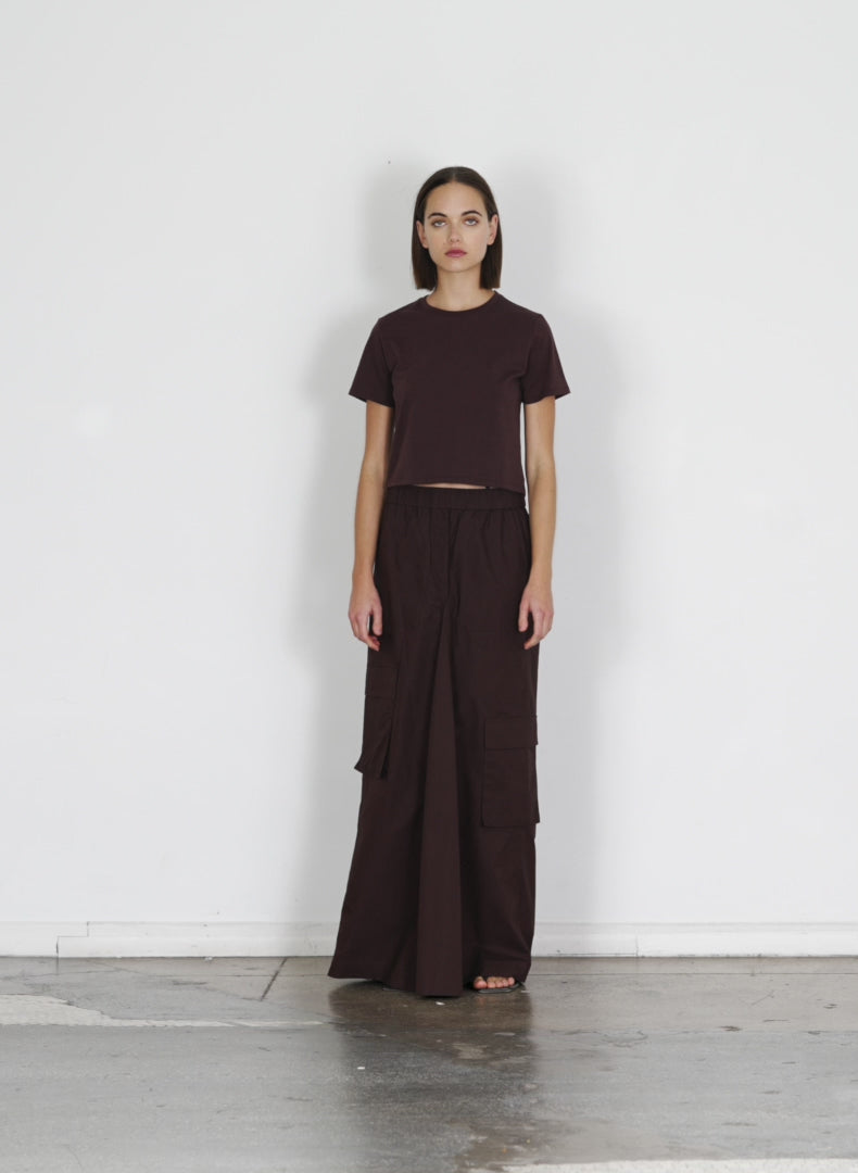Model wearing the vintage cotton pull on cargo godet skirt dark brown walking forward and turning around