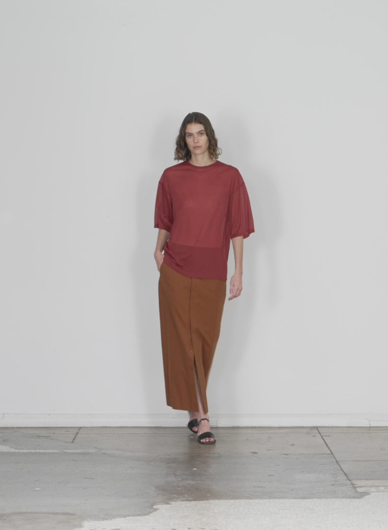 Model wearing the arun suiting back wrap maxi skirt oak brown walking forward and turning around