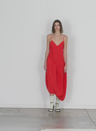 Model wearing the italian sporty nylon cami dress red walking forward and turning around