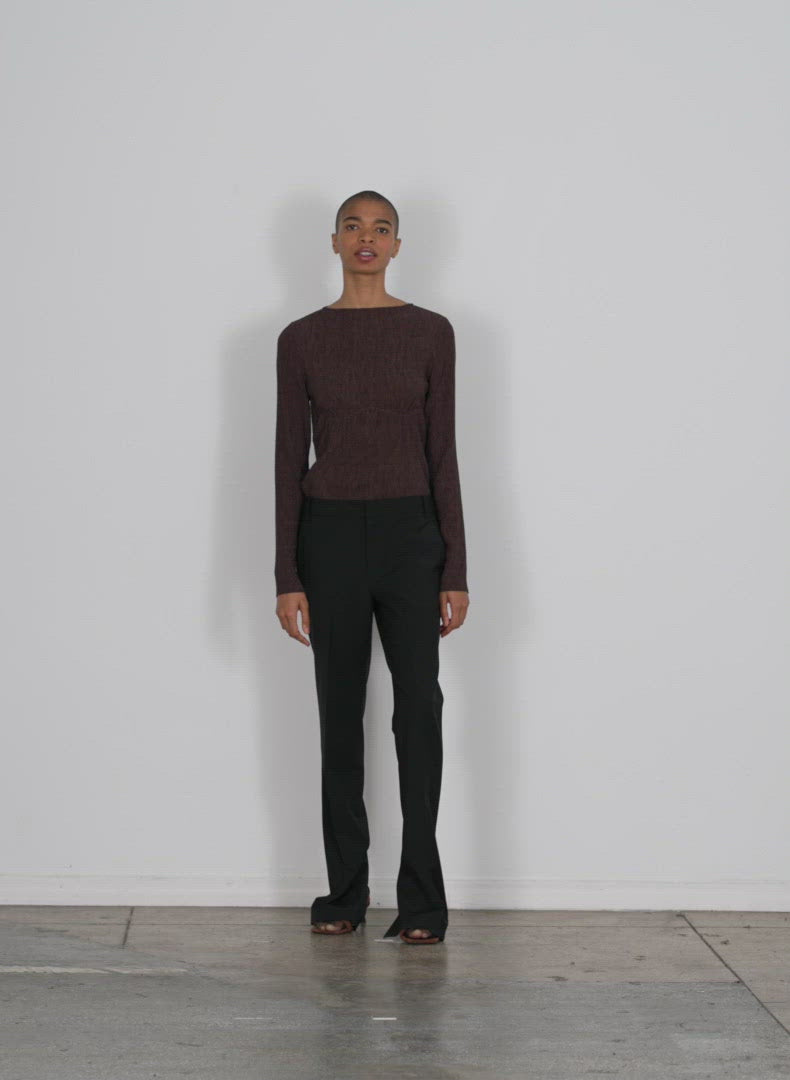 Model wearing the sage crinkle lyocell boatneck long slv t brown walking forward and turning around