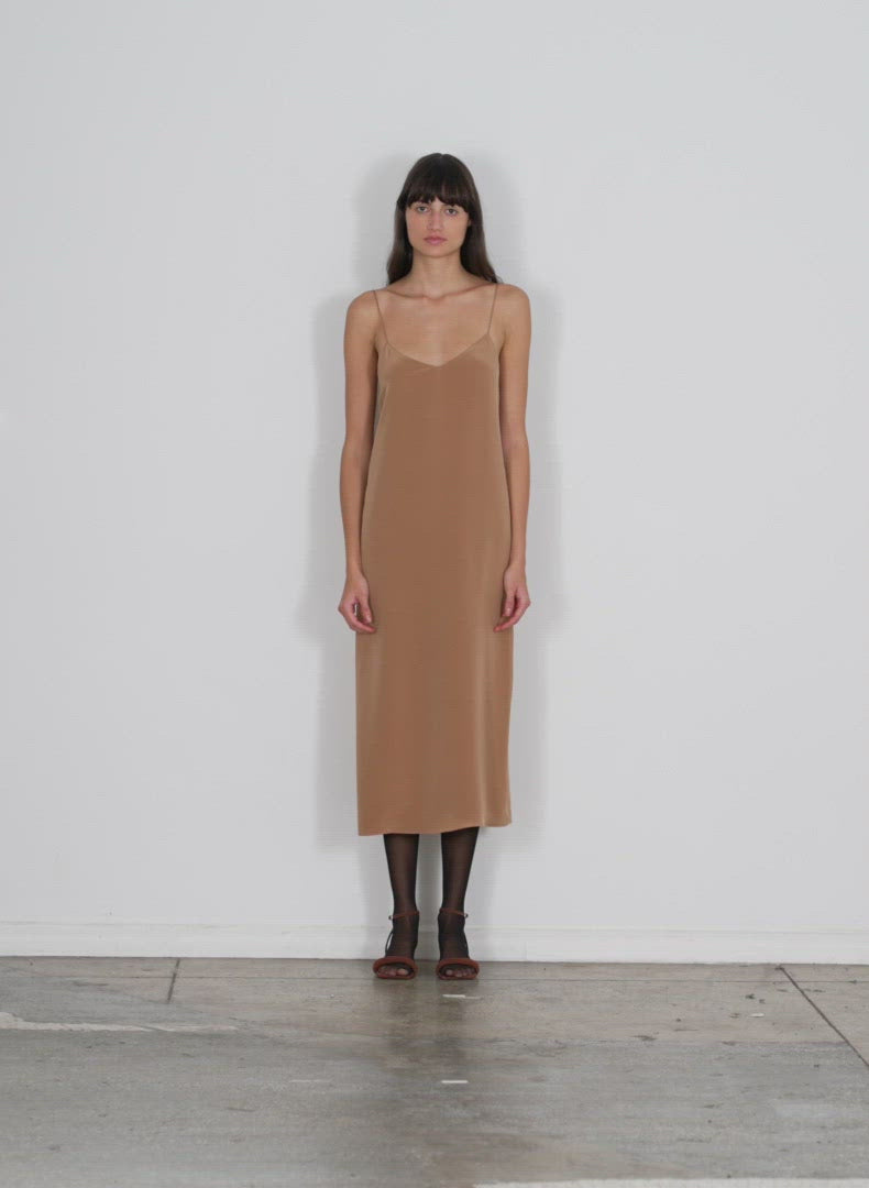 Model wearing the 4ply silk slip dress sunset tan walking forward and turning around