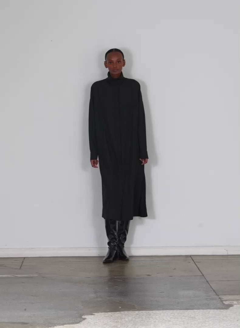 Model wearing the italian sporty nylon shirtdress black walking forward and turning around