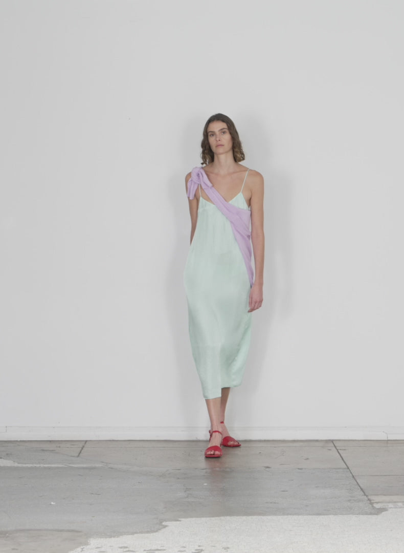 Model wearing the the slip dress mint walking forward and turning around