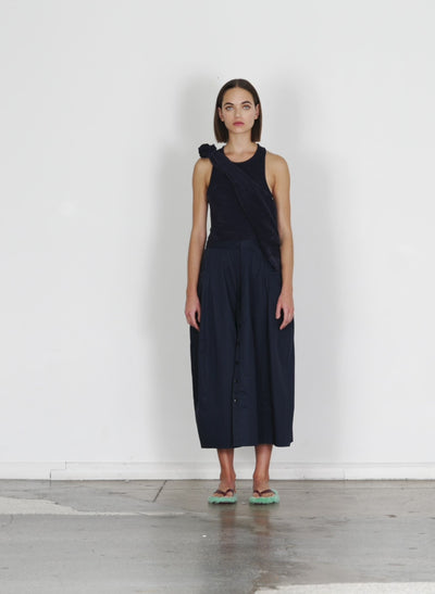 Model wearing the eco poplin lantern skirt dark navy walking forward and turning around