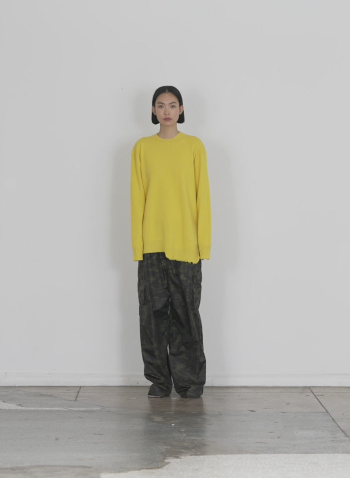 Model wearing the anna merino wool hole at back pullover bright yellow walking forward and turning around