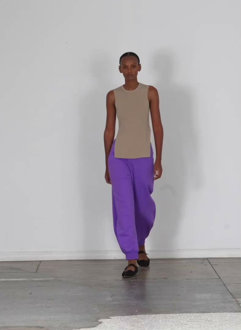 Model wearing the calder longer sweatpant purple walking forward and turning around