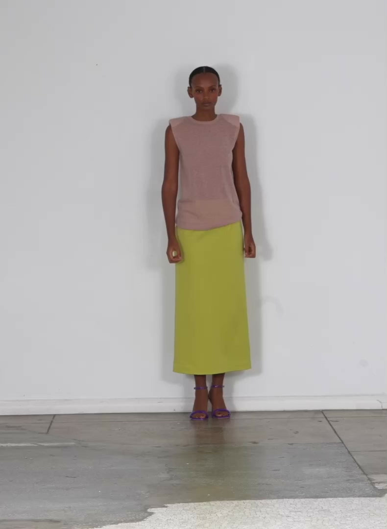 Model wearing the structured knit pencil skirt geko green walking forward and turning around
