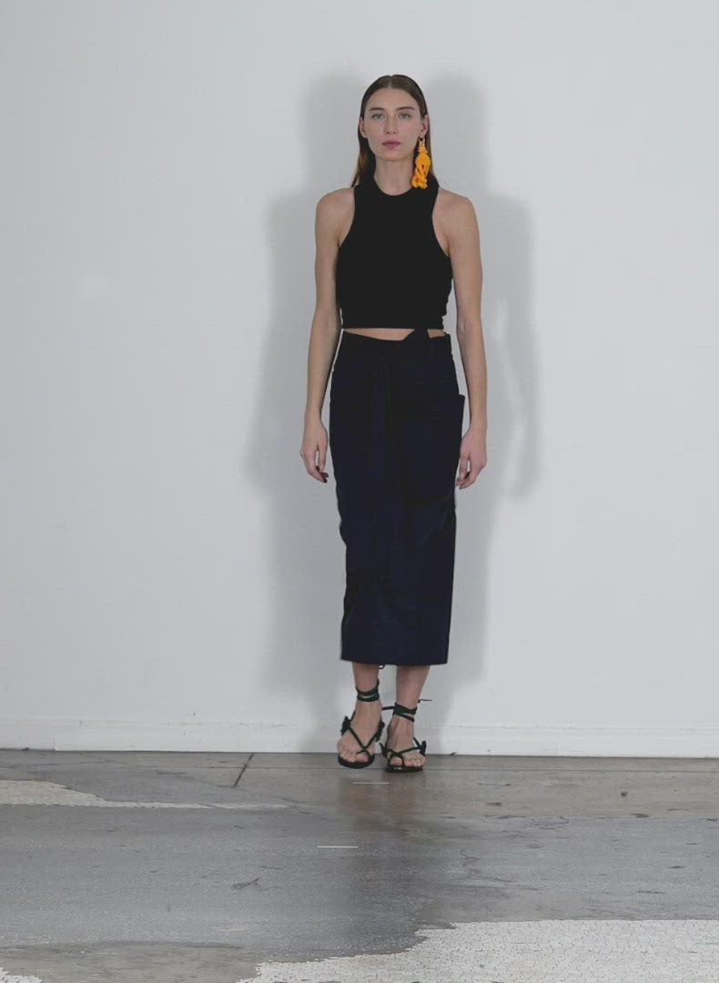 Model wearing the eco poplin lean back wrap skirt dark navy walking forward and turning around