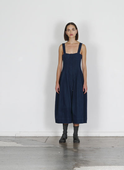 Model wearing the washed summer denim dress dark enzyme wash walking forward and turning around