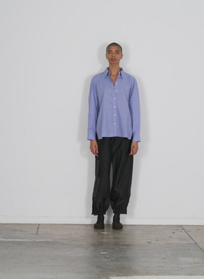 Model wearing the menswear check shirting oversized shirt blue multi walking forward and turning around