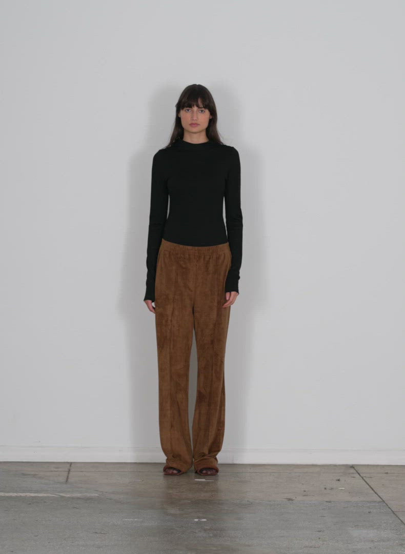 Model wearing the ultrasuede scottie jogger brown rust walking forward and turning around